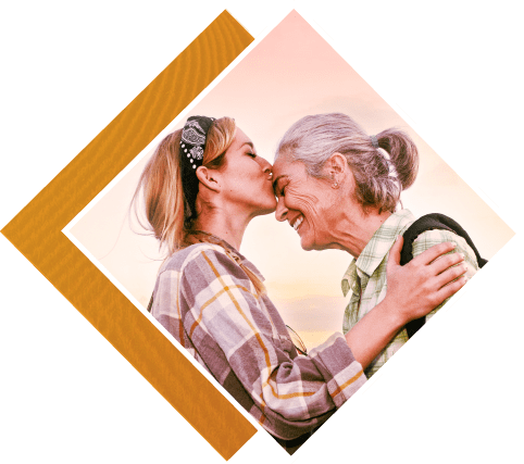 Woman kissing older woman on forehead